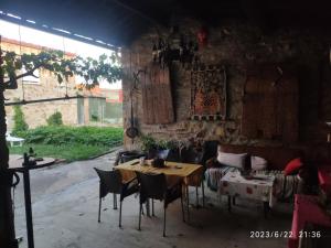 a room with a table and chairs and a couch at El Zoela in Ferreras de Arriba +4 photos