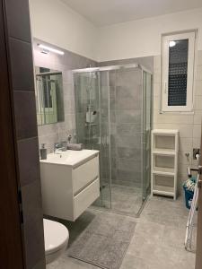 a bathroom with a shower and a sink and a toilet at Marcipán Apartman in Balatonlelle +30 photos