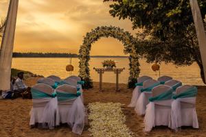 a row of chairs and an arch on a beach at The Oberoi Beach Resort, Lombok in Tanjung
