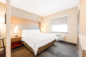 a hotel room with a bed and a window at Holiday Inn - Brownsville, an IHG Hotel in Brownsville