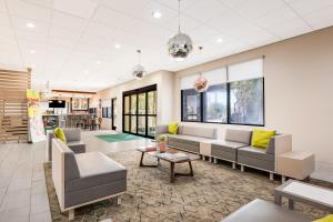 a living room with couches and a table at Holiday Inn - Brownsville, an IHG Hotel in Brownsville