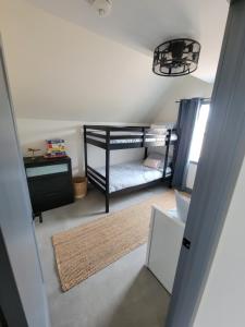 a small room with a bunk bed and a desk at Unique waterfront house with private beach in Gananoque