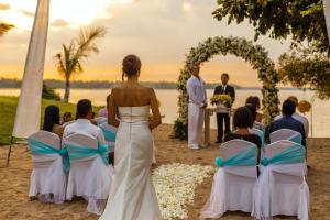 a bride walking down the aisle at a wedding ceremony at The Oberoi Beach Resort, Lombok in Tanjung