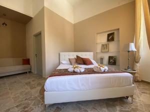 a bedroom with a large white bed with pillows at La Bellavista Decameron View in Certaldo