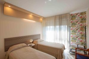 Habitación hospitalaria con 2 camas y ventana en URBAN LIFE FLAT, en Verona