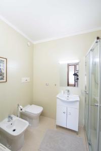 Baño blanco con lavabo y aseo en URBAN LIFE FLAT, en Verona