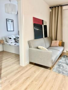 a living room with a couch and a bed at Apartament nad Zalewem w lesie in Serock