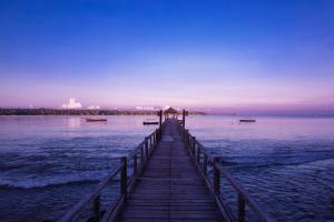 a pier in the middle of the water at The Oberoi Beach Resort, Lombok in Tanjung