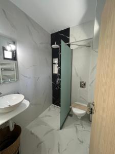 a bathroom with a shower and a sink and a toilet at Vespista Boutique in Skiathos Town