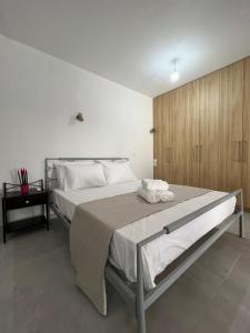 a bedroom with a large bed and a wooden wall at Vespista Boutique in Skiathos Town