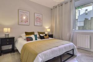 a bedroom with a bed with pillows and a window at La Veore - Baby-foot in Chabeuil