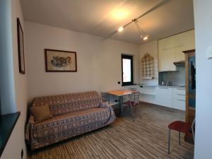 a living room with a couch and a table at Aminta Apartment in Valtesse