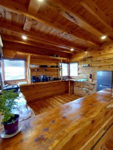 a wooden room with a large wooden table in a cabin at Finca La Gozadera in Jardín