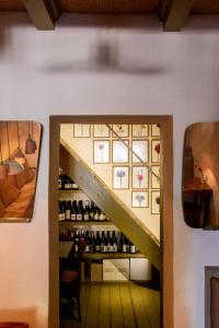 a stairway leading to a room with wine bottles at La Malvina ~5* centro storico~ Giardinetto privato in Santarcangelo di Romagna