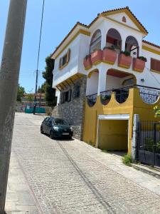 a car parked in front of a yellow and white building at ANASTASIAS HOUSE in Agios Nikolaos