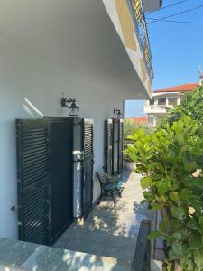 a row of green doors on the side of a building at ANASTASIAS HOUSE in Agios Nikolaos