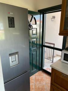 a kitchen with a door leading to a balcony at ANASTASIAS HOUSE in Agios Nikolaos