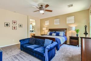 a bedroom with a bed and a blue couch at The Winner's Getaway in Las Vegas