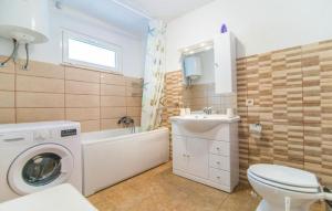 a bathroom with a washing machine and a sink at Apartment Ina in Povlja