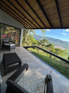 a balcony with chairs and a view of the mountains at Palmar San Gil in San Gil