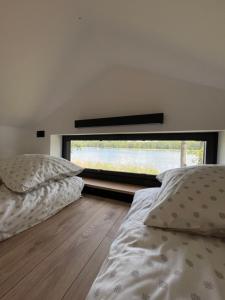 Voodi või voodid majutusasutuse Tiny House - Osada Wilkasy toas