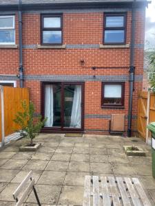 a brick house with a patio in front of it at 2 bed house, walking distance Shrewsbury centre in Shrewsbury