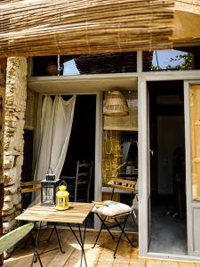 a patio with a table and chairs on a porch at CAN TAT, Loft in a old coach house in Sant Jordi Desvalls