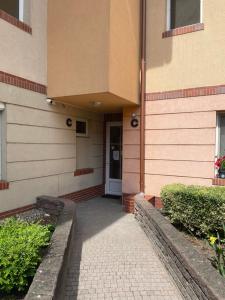 a building with a walkway leading to a door at Apartman 44 in Sopron