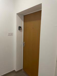 a wooden door in a room with a wall at Apartman 44 in Sopron