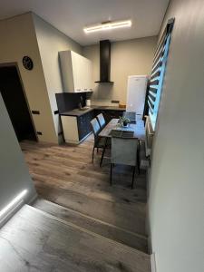 a kitchen and dining room with a table and chairs at ML Place 5 in Liepāja