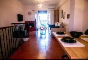 a kitchen and living room with a table and a couch at #On The Rocks in Ouranoupoli