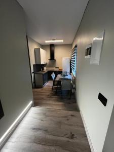 a hallway leading to a kitchen and a dining room at ML Place 5 in Liepāja