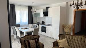 a living room with a kitchen and a dining room at Apartments MIJUTA in Sukošan