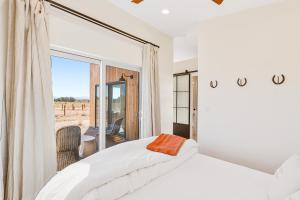 a bedroom with a bed and a large window at The Grand Canyon Headquarters in Valle