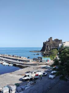 a group of boats parked on a beach next to the ocean at Casa Kalé in Aci Castello