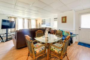 a living room with a table and a couch at 1 Ocean Fun Emerald Isle Apt, Steps to Beaches! in Emerald Isle