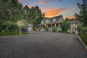 a large house with a driveway in front of it at Jackson River Estate Main House Pool, Riverfront, sleeps 15 in Covington