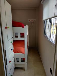 a room with two bunk beds and a window at Luz de Faro, frente a las playas mas lindas! in Mar del Plata