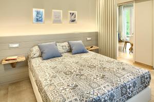 a bedroom with a large bed with blue pillows at La Casa dei Glicini in Levanto