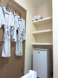 a bathroom with white towels hanging on a door at Brand New Apartament Durres in Durrës +65 photos