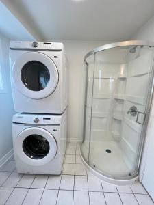a washing machine and a washer in a bathroom at Letitia Heights !A Spacious and Quiet Private Bedroom with Shared Bathroom in Barrie