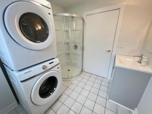 a washing machine in a bathroom with a shower at Letitia Heights !A Spacious and Quiet Private Bedroom with Shared Bathroom in Barrie