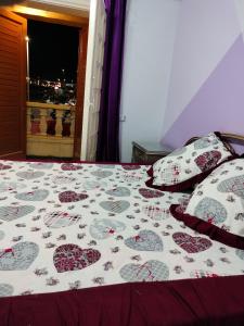 a bed with hearts on it in a bedroom at فيلا للايجار في مارينا 4 حمام سباحة خاص in El Alamein