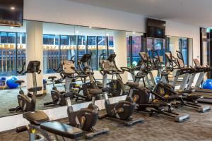 a gym with many treadmills and elliptical machines at Burleigh Beach Escape with Stunning Sunset Views in Gold Coast