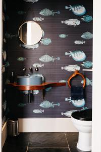 a bathroom with a sink and a fish wallpaper at Grand Historical Listed energy efficient retreat Canterbury completely modernised in Canterbury