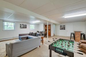 a living room with a pool table at Pasadena Hideaway with Game Room and Fire Pit! in Glen Burnie