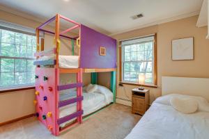 a bedroom with a bunk bed with a ladder at Pasadena Hideaway with Game Room and Fire Pit! in Glen Burnie