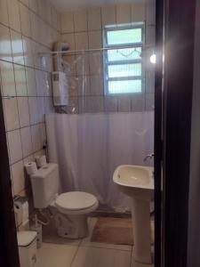 a bathroom with a toilet and a sink at Casa rústica 2 em Santa Teresa in Rio de Janeiro
