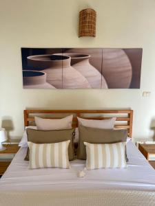 a bedroom with a bed with white sheets and pillows at 21 Palms in Las Galeras