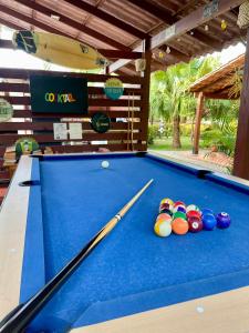 a pool table with a cue and balls on it at 21 Palms in Las Galeras